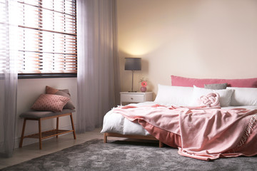 Fototapeta na wymiar Modern room interior with comfortable double bed and window blinds