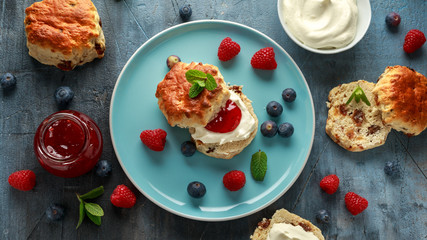 Classic English scones with clotted cream, strawberries jam and other fruit