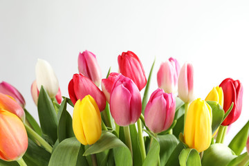 Beautiful bouquet of bright tulip flowers on white background