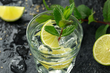 Mojito cocktail with Rum, lime and mint in glass. Summer cold drink with ice
