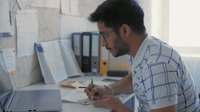 Close-Up, Indian Student Makes a Sketch on a Sticker, Prepares a Cheat Sheet for a Medecin Exam