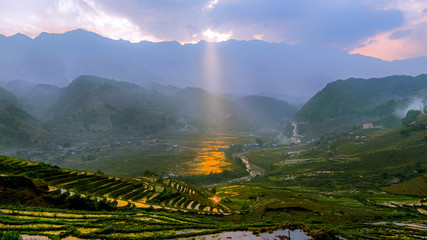 Sunray through clouds and mountains at rice fields in Sapa Vietnam