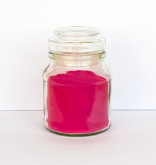 can of red powder, white background, color pigment