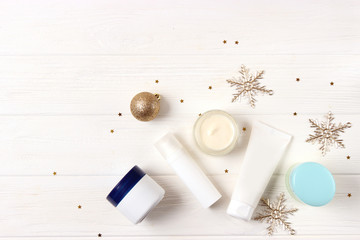 Winter care cosmetics on a colored background top view.