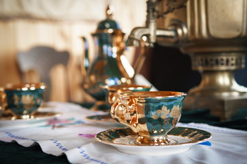 Old mugs on the background of the samovar