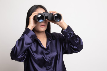 Young Asian woman with binoculars.
