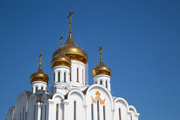 The Golden domes of the Church in the blue sky.