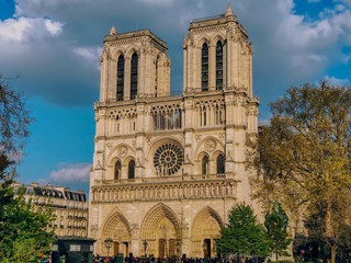 Fototapeta na wymiar Notre-Dame de Paris Cathedral facade in spring time in cloudy weather