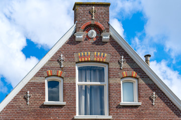 Typical facade of a dutch house with windows.