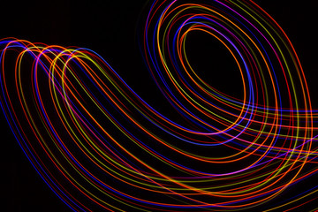 3d illustration. Abstract lines of light painting of reddish colors on black background.