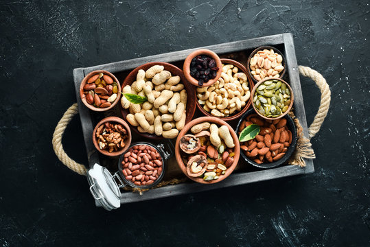 Set Nuts And Dried Fruit In A Wooden Box. Top View. Free Space For Your Text.