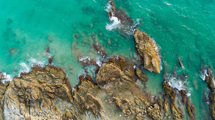 Aerial view drone shot of seascape scenic off beach in phuket thailand with wave crashing on the rocks