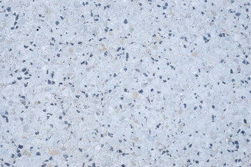 light gray cement slab interspersed with stones