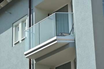 Balkon mit Metallgeländer und Mattglas-Platten als Sichtschutz