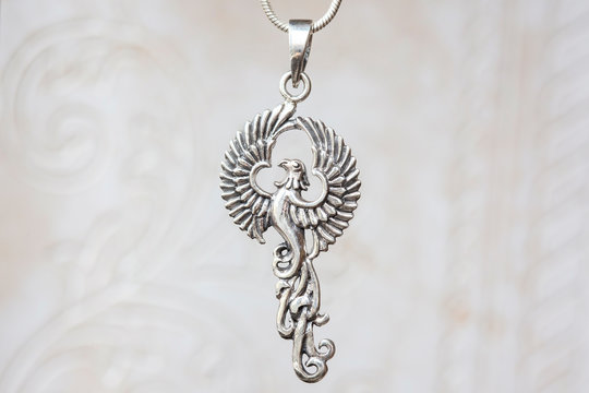 Silver Phoenix Bird Pendant On Natural White Background