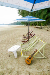 guitar and the couch on the beach with soft tone