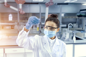 Female scientist looking at the scientific sample in the CDC laboratory