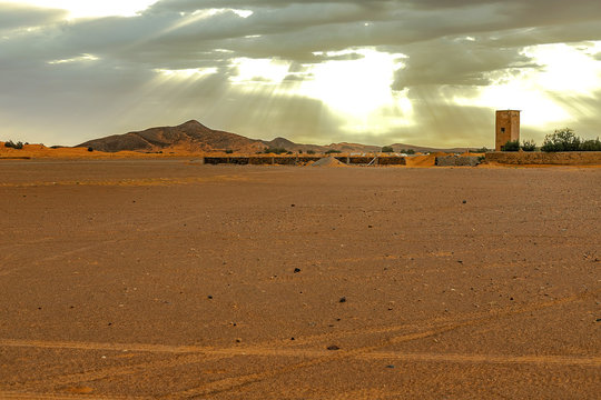 Hamada du Draa, moroccan stone desert in foreground, mountains in background, Morocco