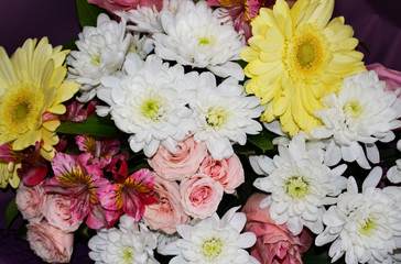 Yellow and white chrysanthemum flowers in a bouquet.