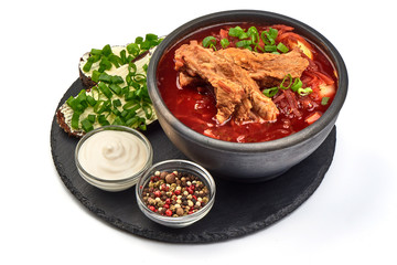 Traditional Ukrainian Russian borscht with pork ribs, close-up, isolated on white background