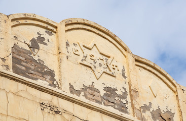 Old weathered building with Star of David and hebrew date 5689 written in hebrew letters...