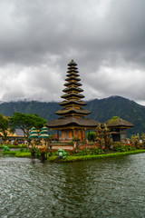 Moody scenic landscape view of Pura Ulun Danu Bratan, Hindu water temple on Bratan lake, tourist most popular attraction in Bali island, Indonesia.