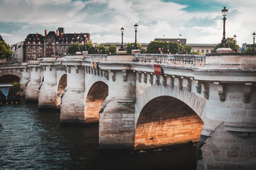 Fototapeta premium Details of the Pont Neuf in Paris on a cloudy summer sky - Paris, France