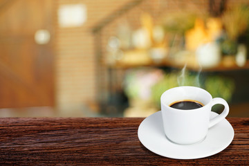 Coffee cup on wooden table on blurred of interior coffee shop. Business time with coffee, Coffee color brown background for product display, free copy space. Industrial food, drink background concept.