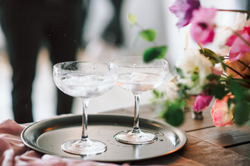 Laying and decor of the wedding banquet table. Plates, knives, forks, glasses, plates, flowers, snacks and fruit. The main thing in the details.