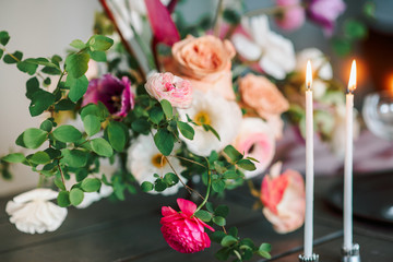 Laying and decor of the wedding banquet table. Plates, knives, forks, glasses, plates, flowers, snacks and fruit. The main thing in the details.
