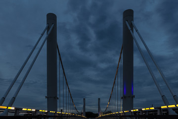 The first suspension bridge in Belgium located in Kanne with a span of 120 against a dramatic evening sky during twilight