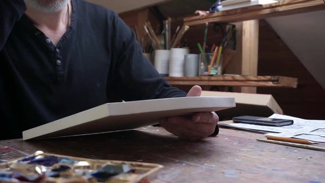 a man taking a canva for drawing
