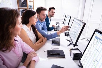 Stock Market Broker Analyzing Gantt Chart On Computer