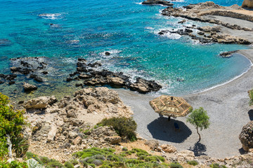 Lounge chairs and umbrella on the pebbles beach.