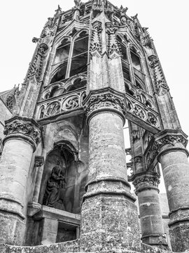 The Recevresse in front of the Basilica of Our Lady, Basilique Notre-Dame in Avioth, France, black and white photography, low-angle view