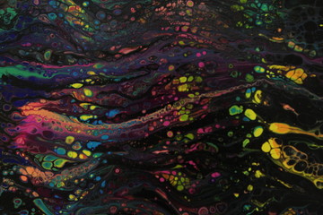 Closeup section of a black abstract acrylic swipe painting with numerous bright colored cells popping up throughout.