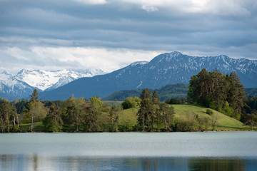 Naklejka na ściany i meble Bavarian landscape with scenic lake and alps in spring