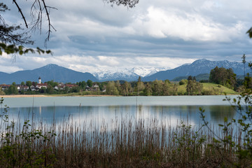 Scenic Bavarian town in spring with lake and alps 