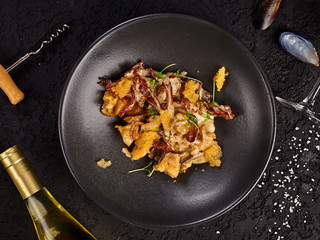 Top view of a dish with mussels with caviar and sauce