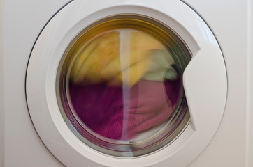 Washing machine door with rotating garments inside