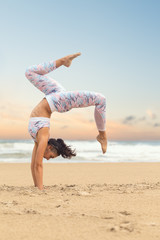 Young beautiful woman practice yoga on sea sand - obrazy, fototapety, plakaty