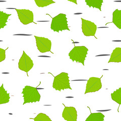 Green leaves of birch fall on the background texture of the trunk