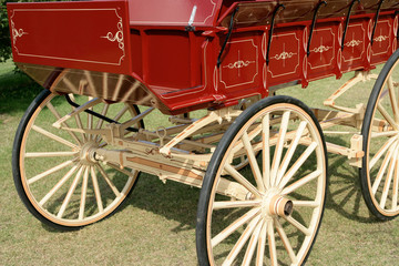 Fototapeta na wymiar restored red and pale yellow wooden horse drawn wagon