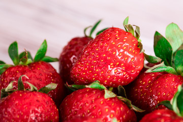 Red juicy strawberry lies on a saucer. Seasonal berries.