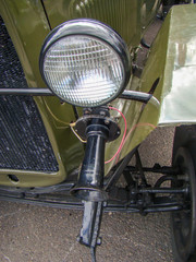 Fototapeta premium Antique passenger car. Green, Black color. Grille, headlight, horn, suspension components.