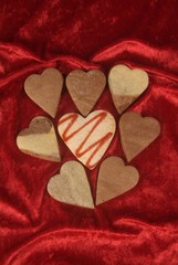 Fototapeta premium Symbol of flower of cookie in form of heart with red jam, copyspace on wooden table.