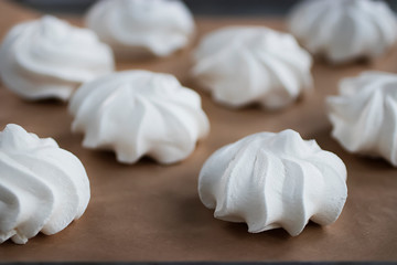 Meringues on a white plate. Dessert Pavlova.