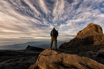The climber stood back and watched the sun rise and breathed the fresh air in the morning at the...
