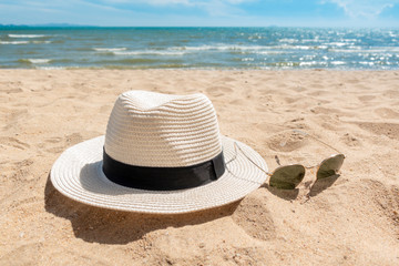 White hat and sunglasses on beach, Summer concept