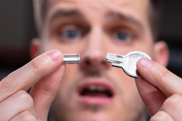 Shocked Person Showing Broken Key
